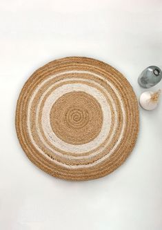 a white table with a brown and beige rug on it