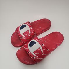 Elevate Your Kid's Casual Look With These Vibrant Red Champion Ipo Repeat Slide Sandals. These Unisex Sandals Are Perfect For Travel, Activewear, And Casual Occasions. They Are Made Of A Comfortable Synthetic Upper Material With A Blended Fabric Lining. The Sandals Feature A Low-Top Shoe Shaft, Standard Shoe Width, And Minimal Cushioning Level. The Rubber Cleat Type And Slip-On Style Make It Easy To Wear And Take Off. These Sandals Are Perfect For Summer, Fall, And Spring Seasons. Buy Them Now A Red Flat Sandals With Rubber Sole, Casual Red Sandals With Rubber Sole, Casual Red Closed Toe Sandals, Comfortable Red Sandals With Round Toe, Red Cushioned Slippers For Summer, Comfortable Red Open Toe Slippers, Trendy Adjustable Red Sandals, Trendy Red Adjustable Sandals, Red Trendy Sandals With Cushioned Footbed