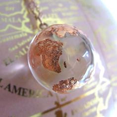 a glass globe is sitting on top of a map