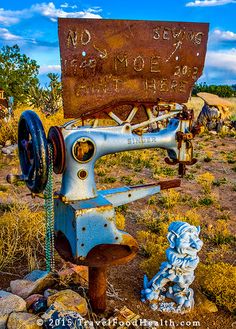 an old sewing machine sitting in the middle of nowhere