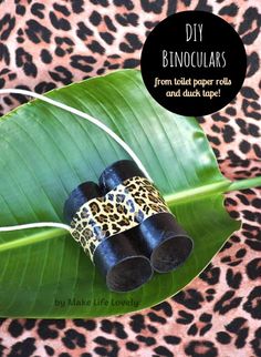 the diy binoculars are made from rolled paper rolls and duct tape on a green leaf