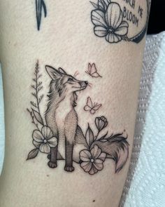 a woman's thigh with a fox and flowers tattoo design on it that says, i love you all