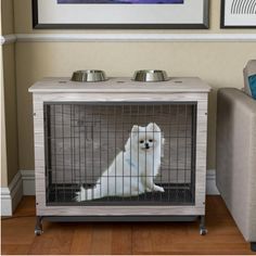 a small white dog sitting in its kennel