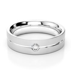 a white gold wedding ring set with a single diamond in the center and two matching bands