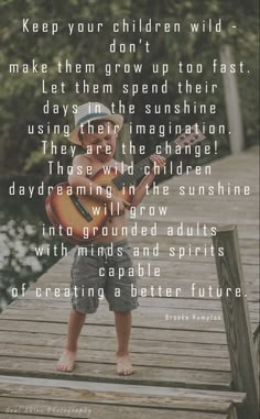 a little boy standing on a dock with a guitar in his hand and the words, keep your children wild - make them grow up to their