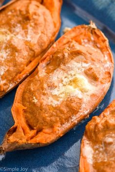 three baked sweet potatoes on a blue plate