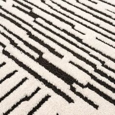 a black and white rug with an interesting design on the bottom part of it's surface