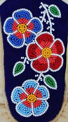 a colorful beaded purse with flowers on it