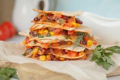 a stack of food sitting on top of a wooden cutting board