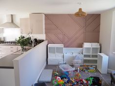 a kitchen with lots of toys on the floor