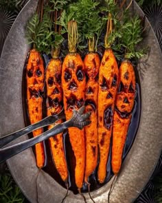 the carrots have been cut in half to look like human faces and are sitting on a plate