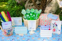 a table topped with lots of different items on top of a blue and white table cloth