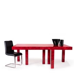 a red table with two black chairs next to it