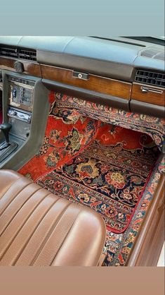 the interior of a car with carpet and leather seats