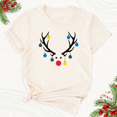 Christmas Lights Reindeer Shirt, Xmas Family Holiday Festive Party Tshirt, Cute Deer Outfit, Christmas Group Party Tee, Xmas Winter Deer Tee. Welcome to BestMomentTees! Step into a world of comfort and style with our handmade shirts from the renowned Bella Canvas brand. The solid colors are 100% pure cotton, while the delightful heather colors are a charming blend of 52% cotton and 48% polyester. 🍃 Each shirt is a true labor of love, meticulously created using the innovative DTF printing method Christmas Shirts With Reindeer, Christmas Shirts With Deer, Reindeer Shirt Target, Deer Outfit, Group Party, Reindeer Christmas Tshirt Unisex, Reindeer Shirt, Xmas Tees, Handmade Shirts