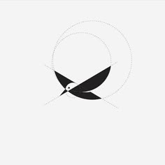 a black and white bird flying through the air with an arrow in it's beak