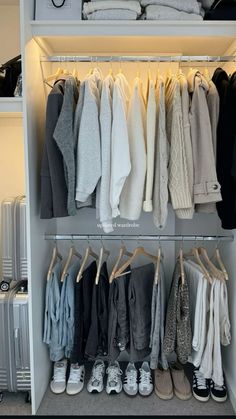 an organized closet with clothes and shoes