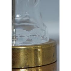 a clear glass and gold base on a table