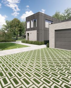 a house with a large lawn in front of it and two garages on the other side