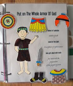 an open book with paper cutouts on the front and back of it, depicting children's clothing