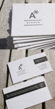 several business cards are stacked on top of each other in front of a wooden table