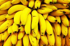 bunches of bananas hanging from the top of each other in an arrangement on display