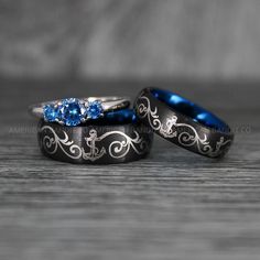 two wedding rings with blue and white diamonds