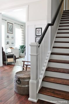 the stairs in this house have been painted white and are lined with wood flooring