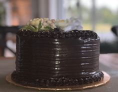 a chocolate cake sitting on top of a wooden table