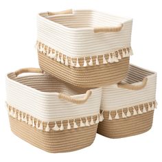 three woven baskets with tassels on them