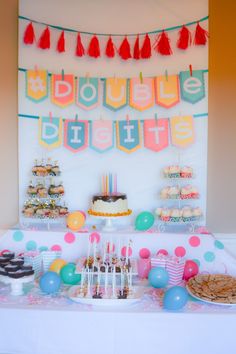 a table topped with lots of cake and cupcakes