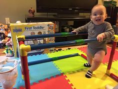 a baby sitting on top of a play mat