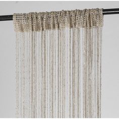 a close up of a curtain with beads hanging from it's side on a metal rod