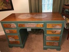 a green desk with drawers in front of a window