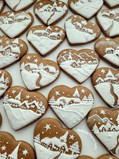 many heart shaped cookies with white frosting on them