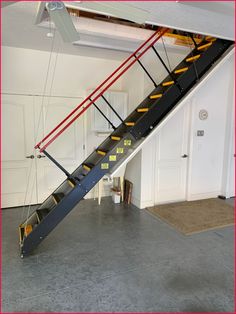 a stair case with yellow steps in a garage