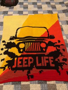 a crocheted blanket with an image of a jeep on it