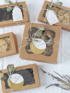 four boxes filled with cookies sitting on top of a table