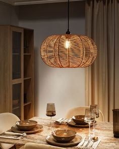 a dining room table with plates and glasses on it