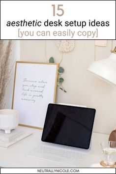 a laptop computer sitting on top of a white desk next to a lamp and other items