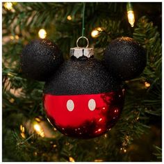 a mickey mouse ornament hanging from a christmas tree