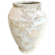 an old white vase with peeling paint on the outside and inside, sitting in front of a white background