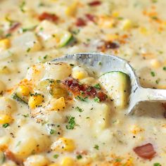 a white bowl filled with corn chowee and topped with a ladle full of soup