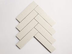 several pieces of white tile stacked on top of each other in the shape of a rectangle