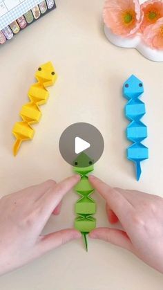 someone is making origami fish with their hands