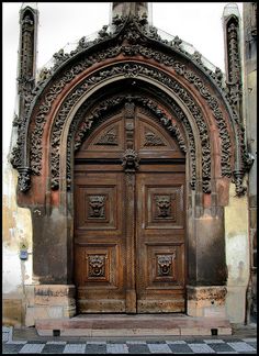 an old wooden door with intricate carvings on the front and side doors are open to let in light