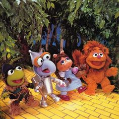 the muppets and miss piggy are standing in front of some trees