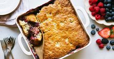 a blueberry cobbler with fresh berries on the side