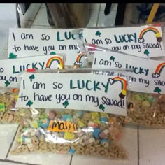 three bags filled with lucky charms sitting on top of a tiled floor next to each other