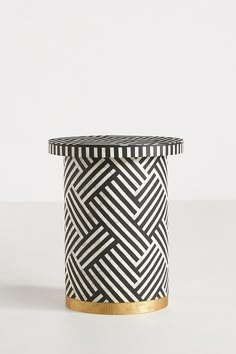 a black and white vase sitting on top of a table